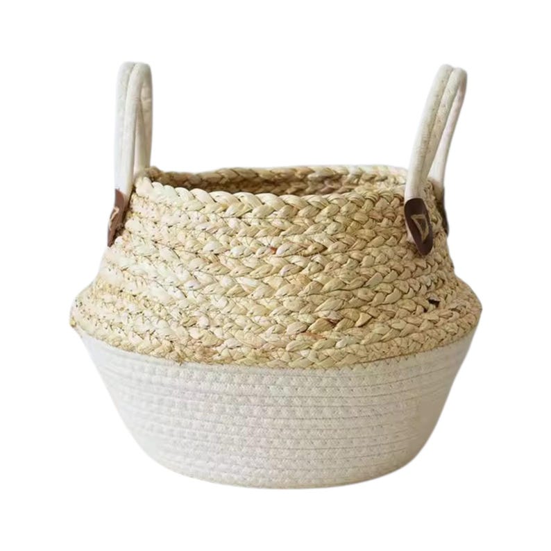 May include: A two-toned storage basket featuring a natural tan woven straw upper section and a solid off-white cotton rope base. The basket includes two upright off-white handles attached with small dark brown leather-like triangular accents.