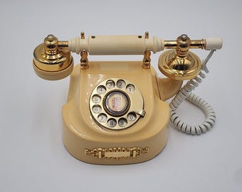 Teléfono antiguo Western Electric estilo princesa francesa con dial giratorio, color marfil.
