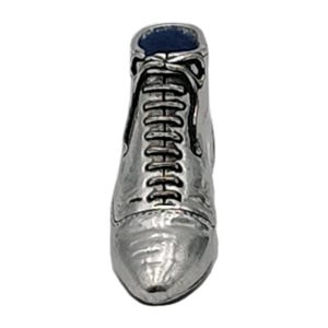 May include: A silver-colored miniature boot charm with a lace-up design. The boot has a pointed toe and a blue interior. The charm is likely made of metal and is set against a white background.