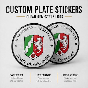 Könnte beinhalten: Zwei individuelle Kennzeichenaufkleber mit dem Text "CUSTOM PLATE STICKERS" und "CLEAN OEM-STYLE LOOK". Die Aufkleber zeigen ein Schilddesign mit einem weißen Pferd, grünen und roten Abschnitten sowie dem Text "NORDRHEIN - WESTFALEN" und "STADT DÜSSELDORF".