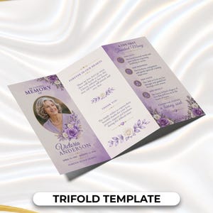 May include: A tri-fold funeral program template featuring a purple watercolor floral design. The front displays a photo of a person, the text In Loving Memory of Victoria Anderson, and dates. The interior includes sections titled Forever in Our Hearts, A Life That Touched Many, and Thank You.