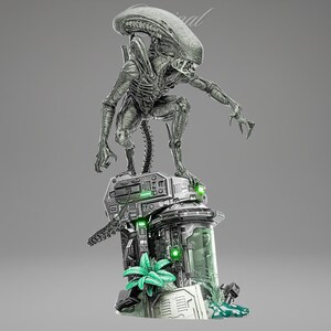 May include: A detailed, silver-toned sculpture of an Alien creature, posed atop a futuristic, mechanical base with green accents. The sculpture features intricate detailing of the creature's exoskeleton and elongated limbs. The base includes a glass-like container and plant-like elements.
