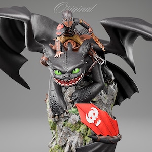 May include: A detailed statue of a black dragon with green eyes, a red and white shield, and a rider in brown and red armour. The dragon is perched on a rocky base with large black wings spread behind it. The word "Original" is written in cursive at the top.