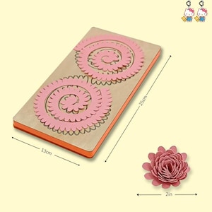 May include: A wooden die-cut tool for crafting paper flowers. The tool is rectangular, measuring 13cm x 25cm, with two pink spiral designs. A finished pink paper flower, 2 inches in diameter, is also shown.