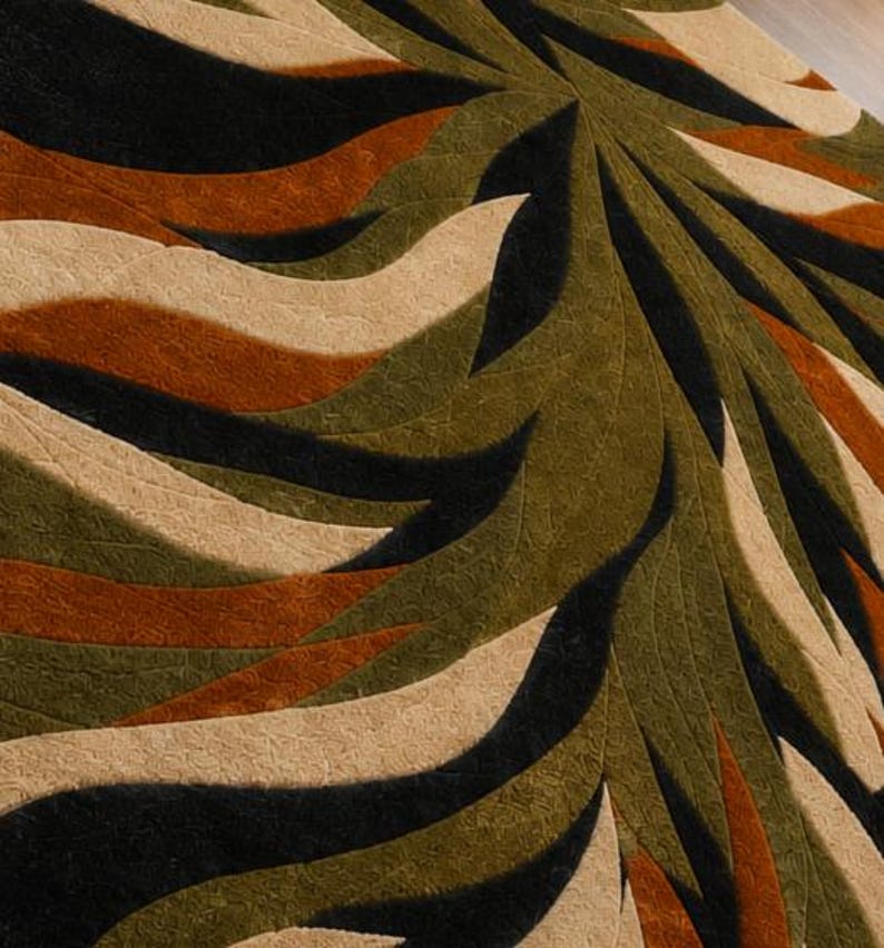 May include: A textured area rug featuring a repeating radial pattern of curved, wave-like shapes in alternating shades of black, olive green, burnt orange, and cream. The surface has a distinct, fine-grained, embossed or carved texture.