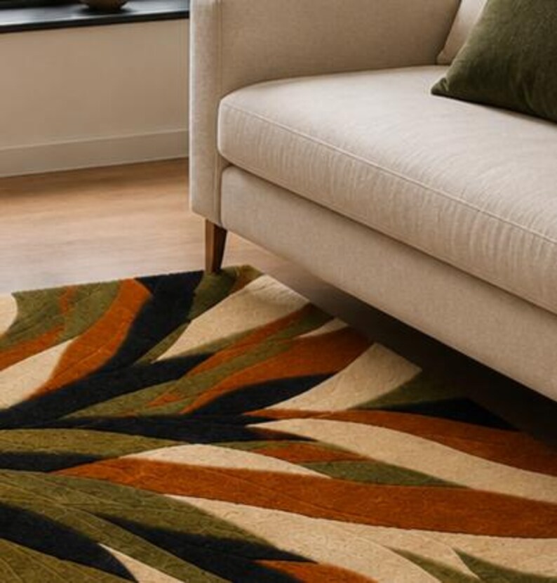 May include: A rectangular area rug featuring a bold, abstract pattern of sweeping, curved bands in shades of olive green, burnt orange, black, and cream. The design creates a dynamic, layered effect across the surface of the floor covering.