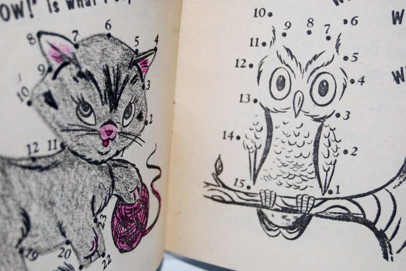 May include: A connect-the-dots activity book page with two illustrations. The first illustration is a gray cat holding a ball of yarn. The second illustration is an owl perched on a branch. The numbers 1 through 22 are next to dots on the cat illustration. The numbers 10 through 15 are next to dots on the owl illustration.