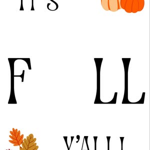 May include: A white sign featuring the black text IT'S FALL Y'ALL! with the letter A replaced by two orange pumpkins. The design includes a cluster of three autumn leaves in shades of orange, yellow, and maroon in the bottom left corner.