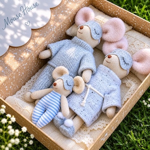 May include: A collection of handmade mouse dolls in a wooden box. The mice are dressed in blue sleep masks and pyjamas. One mouse wears blue and white striped pyjamas. The box is lined with lace and has the text "Mouse House".