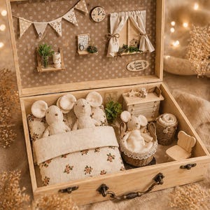 May include: A wooden box containing a miniature bedroom scene. It features two stuffed mice in a bed with floral bedding, a basket with a mouse, a small chair, and a dresser. The box includes a miniature window, clock, and shelves.
