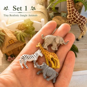 May include: A set of four miniature jungle animal figurines including a gray elephant, a yellow and brown giraffe, a white and black striped zebra, and a gray rhinoceros. The text Set 1 Tiny Realistic Jungle Animals is visible above.