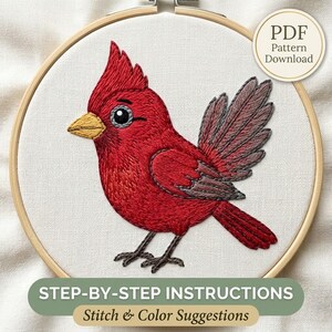 May include: An embroidery hoop containing a stitched cardinal bird with bright red feathers, a yellow beak, and dark gray wings. The design includes a circular badge stating PDF Pattern Download and a banner reading STEP-BY-STEP INSTRUCTIONS.