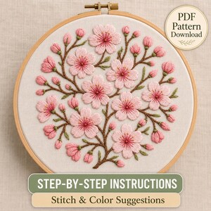 May include: An embroidery hoop containing a fabric piece with hand-stitched pink cherry blossoms and brown branches. A circular badge in the corner reads PDF Pattern Download. Text at the bottom reads STEP-BY-STEP INSTRUCTIONS Stitch & Color Suggestions.