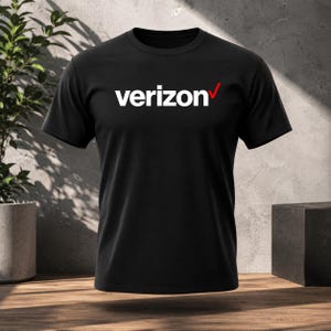 May include: A black short-sleeved t-shirt featuring the white text verizon with a red checkmark logo centred on the chest. The garment has a crew neckline and a standard fit, constructed from a solid black fabric with a clean, smooth finish.