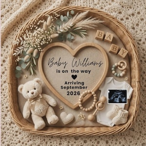 May include: A wicker basket containing a heart-shaped wooden frame with the text Baby Williams is on the way, Arriving September 2026. Includes a beige teddy bear, wooden baby blocks, a white onesie with an ultrasound, booties, and a rattle.