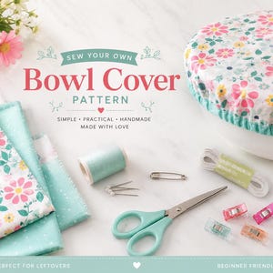 May include: A sewing pattern for a bowl cover featuring text that reads SEW YOUR OWN Bowl Cover PATTERN SIMPLE PRACTICAL HANDMADE MADE WITH LOVE. Includes floral fabric, mint thread, pins, a safety pin, elastic, scissors, and colorful clips.