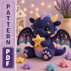 May include: A crocheted dragon toy in shades of blue, purple, and yellow, holding a yellow star. The dragon has large eyes and wings with a starry design. The image also includes the text "PATTERN PDF".