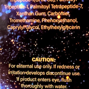 May include: A black product label with gold text listing ingredients including Aqua, Glycerin, Sodium Hyaluronate, and various peptides. It includes a caution for external use only and states a shelf life of 3 years with an expiration date of 2029-04-09.