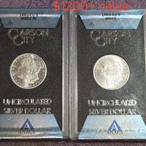 May include: Two silver dollar coins encapsulated in rectangular ANACS plastic holders. The left coin is labeled 1883-CC MS63 PL and the right coin is labeled 1884-CC MS63. Both holders feature the text Carson City and Uncirculated Silver Dollar.