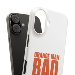 May include: A white phone case with the words "ORANGE MAN BAD" in orange block letters. The case is next to a black smartphone with two camera lenses.