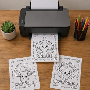 May include: A black printer is printing colouring pages of vegetables. The pages feature a cartoon garlic, mushroom, and cabbage. A small succulent plant in a beige pot and a pencil holder with coloured pencils are also visible.