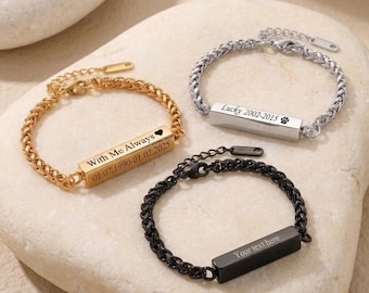 May include: Three metal chain bracelets with rectangular bars. One gold-tone bracelet is engraved with "With Me Always" and a heart. One silver-tone bracelet is engraved with "Lucky 2002-2015" and a paw print. One black bracelet is engraved with "Your text here".