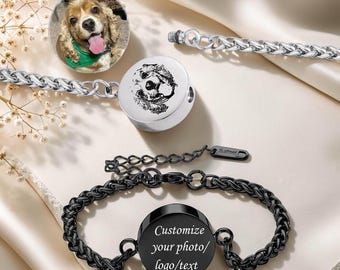 May include: A collection of pet memorial jewelry, including a black bracelet with a round pendant that reads "Customize your photo/logo/text." Other pieces include a silver chain bracelet with a round pendant featuring a dog's face.