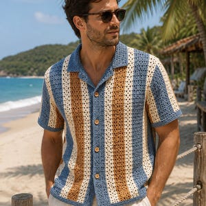 May include: A short-sleeve button-down shirt featuring a crochet knit texture with vertical stripes in shades of blue, tan, and cream. The garment has a classic collar, a buttoned front placket with light brown buttons, and a straight hemline.