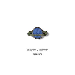 May include: An embroidered patch shaped like the planet Neptune with a blue sphere and green rings outlined in black thread. The text W:45mm / H:27mm and Neptune is printed below the patch, indicating a width of 45mm and a height of 27mm.