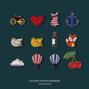 May include: A collection of embroidered patches featuring various designs, including a bicycle, heart, cat in sunglasses, anchor, birds, wine bottle, fox, cloud, hot air balloons, and cherries. The text "STITCHED CENTURY HANDWORK" and "HAND EMBROIDERED" are at the bottom.