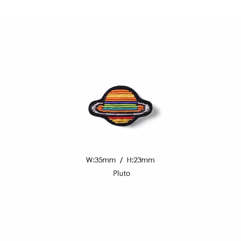 May include: An embroidered patch shaped like a planet with rings, featuring horizontal stripes in red, orange, yellow, green, blue, and purple. The patch has a black border and text below reading W:35mm / H:23mm and Pluto.