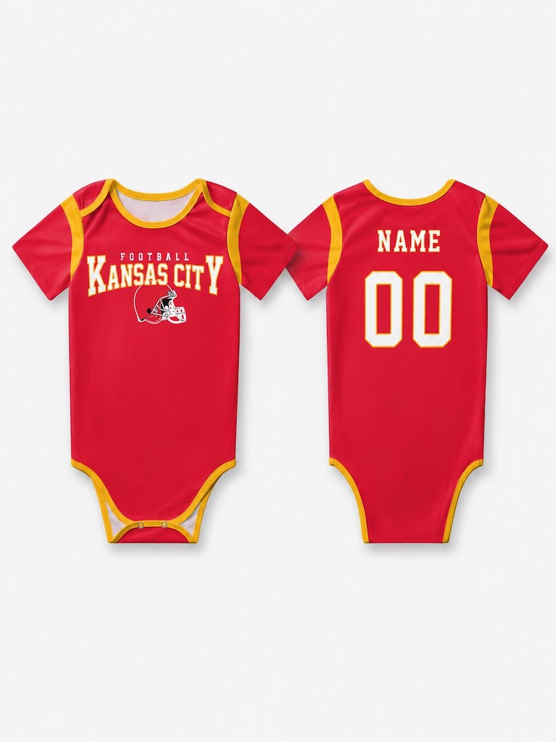 May include: A red and yellow short-sleeve bodysuit featuring the text Kansas City Football with a helmet graphic on the front. The back displays the word NAME above the number 00 in white lettering with a yellow outline on a red background.