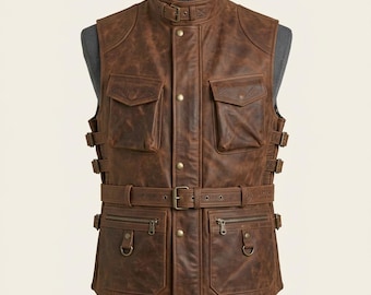 Peut inclure: Un gilet en cuir marron doté d'un col montant avec une sangle à boucle, d'une fermeture à boutons sur le devant et d'une ceinture à boucle métallique. Le gilet comprend deux poches à rabat supérieures, deux poches zippées avec anneaux en D.
