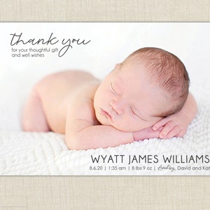 May include: A newborn baby boy, Wyatt James Williams, is sleeping peacefully on a white blanket. The baby was born on 8.6.20 at 1:35 am and weighed 8 lbs 9 oz. The text "Loved by, David and Kat" is also included.