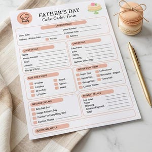 May include: A Father's Day cake order form printed on white paper with peach-colored accents. The form includes sections for order, client, and cake details, size, shape, theme, message, and payment. A gold pen and stacked macarons are nearby.