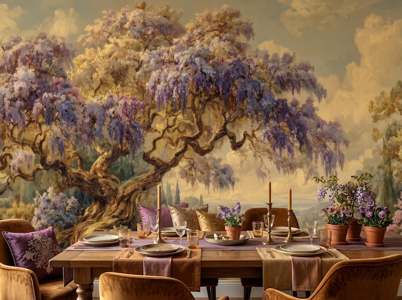 May include: A dining room scene with a large mural of a tree with purple flowers. A wooden table is set with plates, glasses, candles, and potted plants. The chairs are upholstered in a warm, golden-brown fabric.
