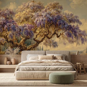 May include: A bedroom with a large mural of a tree with purple flowers and a beige bed. The mural is the focal point, with the tree's branches and flowers dominating the scene. The bed has a neutral color palette, with beige bedding and pillows. A small side table and ottoman complete the room.