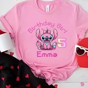 May include: Pink t-shirt featuring a cartoon character holding cupcakes, with the text "Birthday Girl", the number "5", and the name "Emma". The design is in shades of pink and purple.