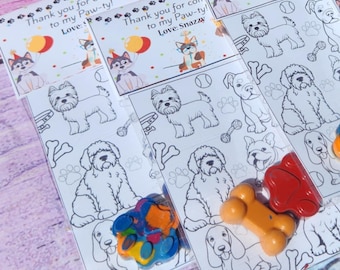 May include: A set of six dog-themed coloring pages with crayons. Each page features a different dog breed, including a Yorkshire Terrier, a Golden Retriever, a Bulldog, a French Bulldog, a Dachshund, and a Poodle. The pages are printed on white cardstock and are packaged in clear cellophane bags. The text on the pages reads "Thank you for coming to my Paw-ty! Love: Snazzy".