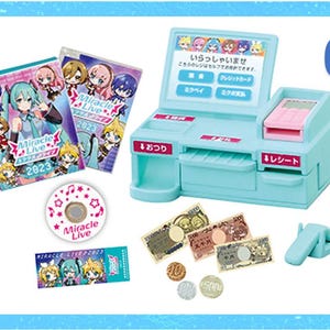 May include: A light blue toy cash register with a pink keypad, surrounded by miniature Japanese currency, a CD, tickets, and two booklets labeled "Miracle Live 2023".
