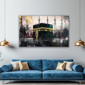May include: A rectangular wall art print depicting the Kaaba in Mecca, featuring a dark green and black structure with gold calligraphy accents. The scene includes tall minarets in the background and a textured, painterly style with light.