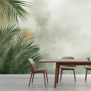 May include: A dining room scene featuring a wooden table and four chairs. The table is set with a vase of dried flowers and decorative bowls. The background is a green and white mural with palm fronds and other greenery.