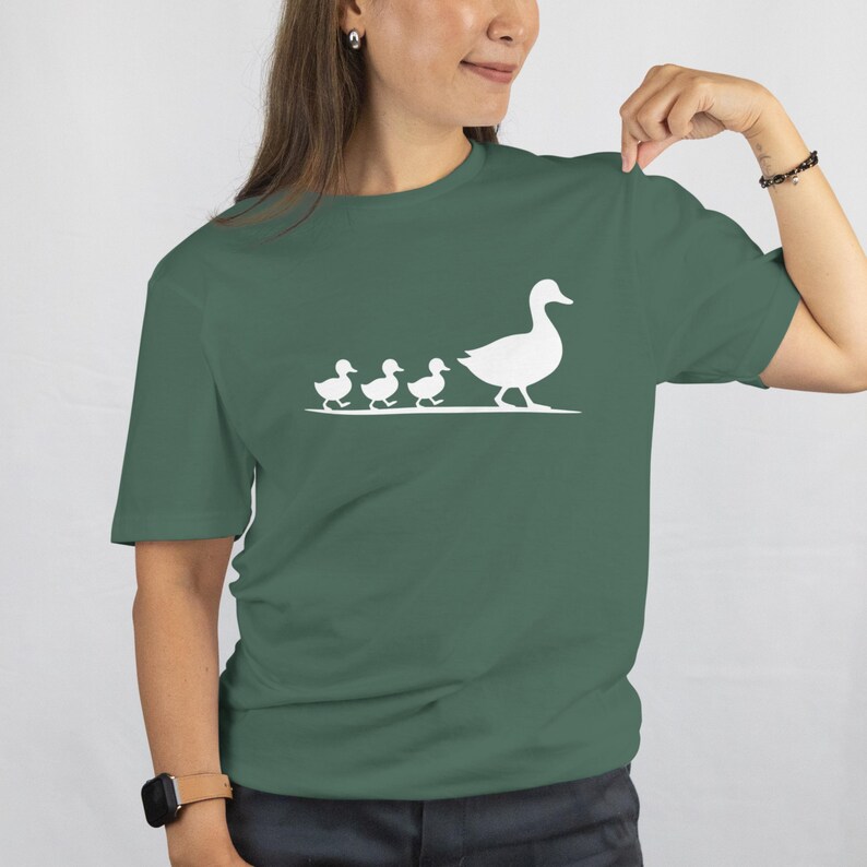 Cute minimalist duck family shirt styled casually with denim jeans and cozy aesthetic vibes.