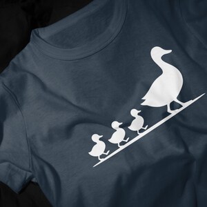 Cute duck family unisex shirt with simple white duckling illustration and cozy casual style.