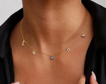 Collar con dije chapado en oro, símbolo del ojo turco, infinito, copo de nieve, herradura y libélula.