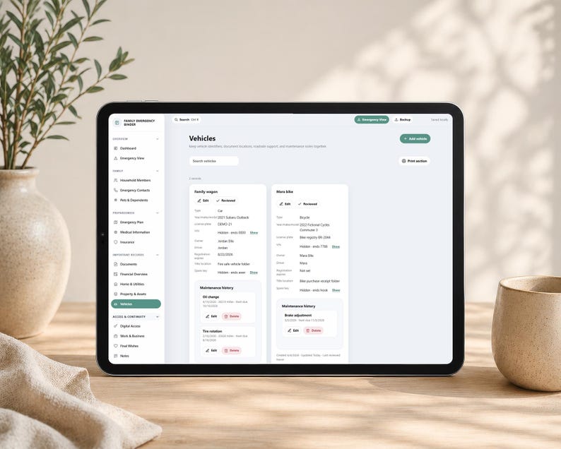 May include: A tablet displaying a digital family emergency binder interface with a sidebar menu and a main content area titled Vehicles. The screen shows detailed information for a family wagon and a bike, including maintenance history and records.