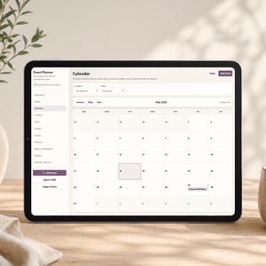 May include: A digital tablet displaying an event planner calendar interface. The screen shows a monthly calendar view for May 2024, with event details. The tablet is on a wooden surface, next to a vase with greenery and a ceramic cup.