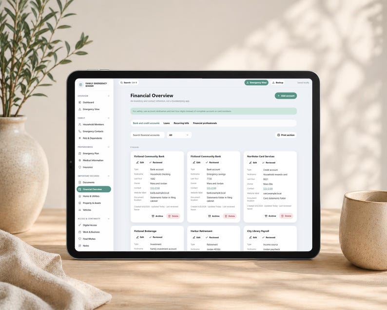 May include: A tablet displaying a digital financial overview dashboard titled Family Emergency Binder. The interface features a sidebar with navigation categories and a main area showing bank and credit account details with edit and archive buttons.