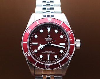 Refurbished Tudor Geneve Chronometer Automatic Movement In Red Dial With Rotating Bezel.