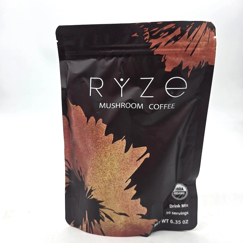 May include: A black and brown pouch of RYZE Mushroom Coffee. The pouch features the brand name in white, with the words "Mushroom Coffee" below. The bottom right corner has the text "USDA Organic", "Drink Mix", "30 servings", and "WT 6.35 OZ".